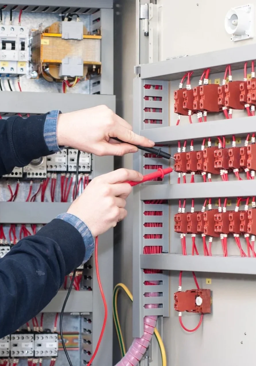 A person is working on an electrical panel.